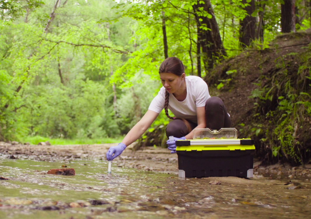 Water Resources Technician sampling a creek